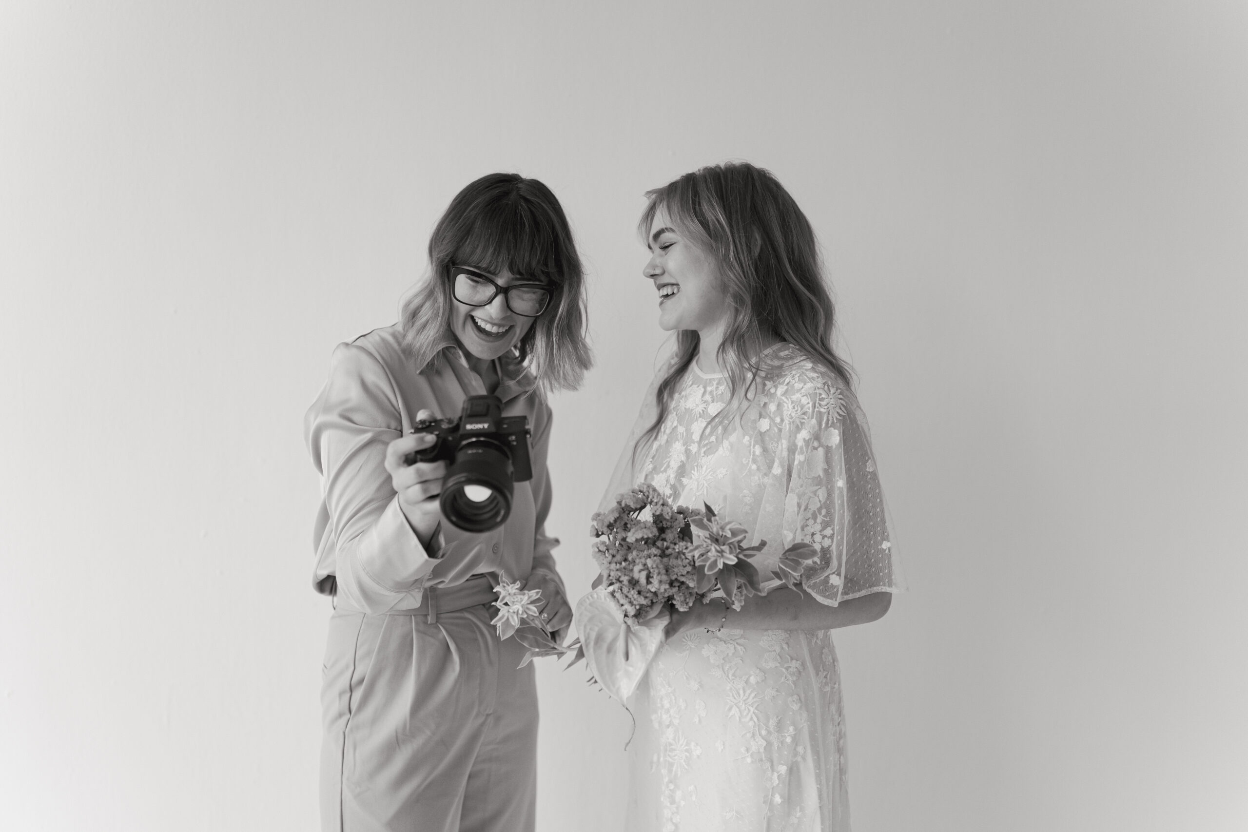 Wedding Photographer showing back of camera to bride