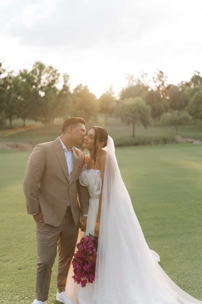 Groom kissing bride