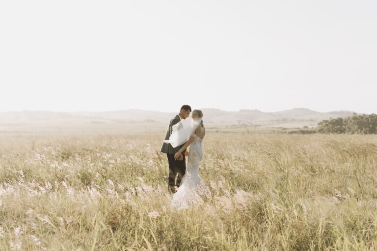 Bride and groom in field