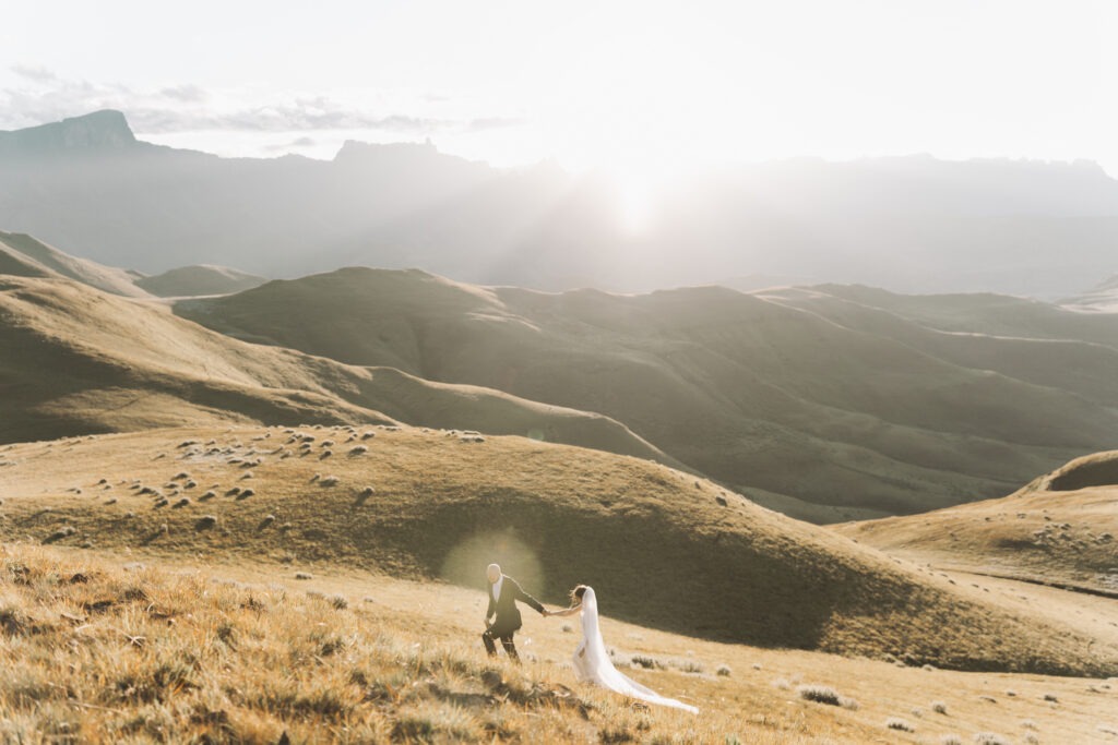 Bride and groom walking in the Drakensberg, South Africa