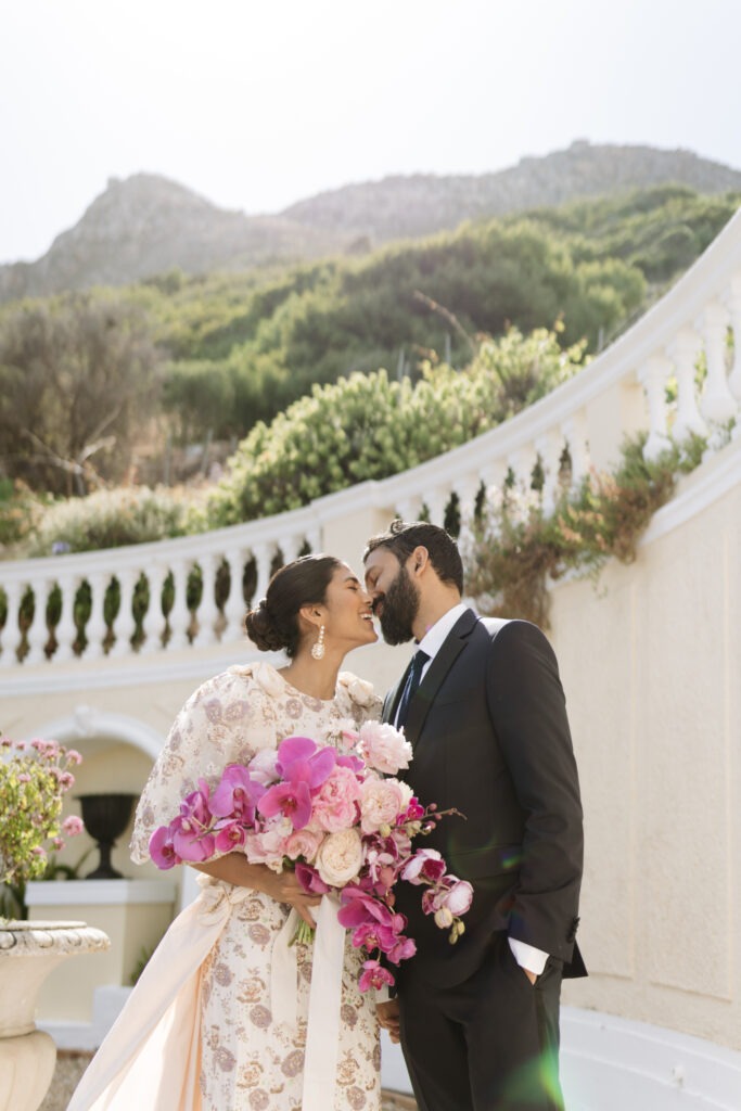 Bride and groom with luxury attire kissing in Cape Town