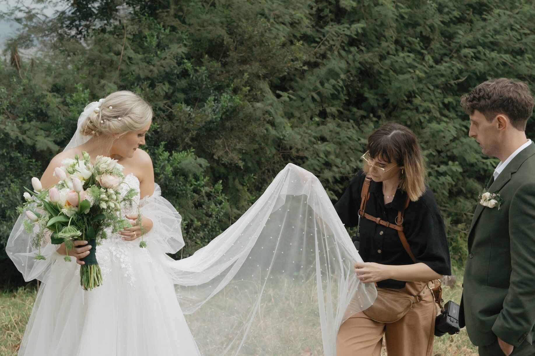 Photographer attending to bride