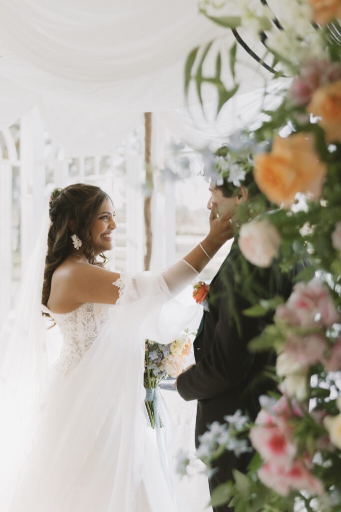 Moment between bride and groom amoungst flowers