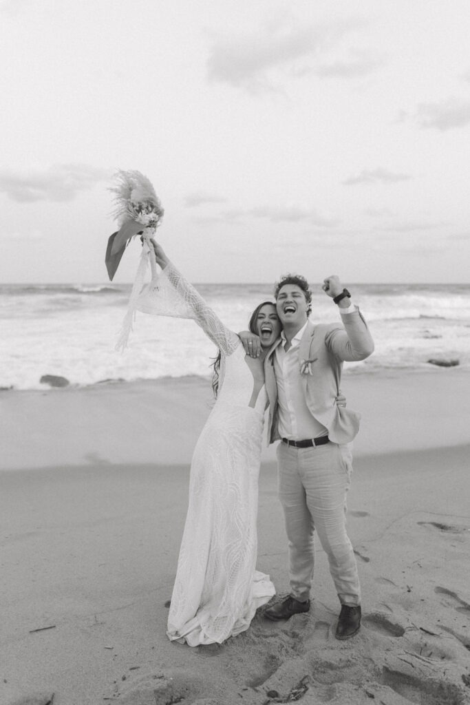 Energetic bride and groom celebrating at their boho Cape Town wedding with a fun candid photography style
